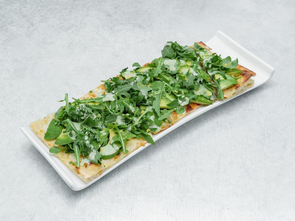 Avocado Flat Bread Pizza · Organic flatbread, avocado, green goddess sauce, Manchego, mozzarella, baby arugula