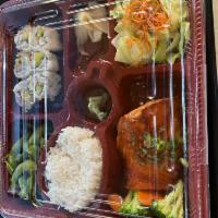 Salmon Teriyaki Bento box · Salmon Teriyaki includes California roll, Edamame, a small salad, miso soup &rice