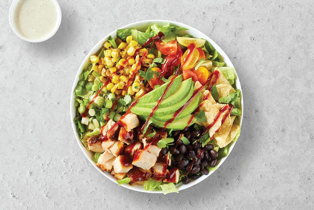 Southwest Chicken · Fresh grilled bbq chicken, avocado, roasted corn, black beans, cherry tomatoes, corn chips, cilantro, green onions on chopped hearts of romaine, with avocado-ranch dressing on the side.