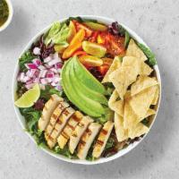 Avocado Green · Fresh grilled chicken breast, avocado, red onions, cherry tomatoes, corn chips on a bed of s...