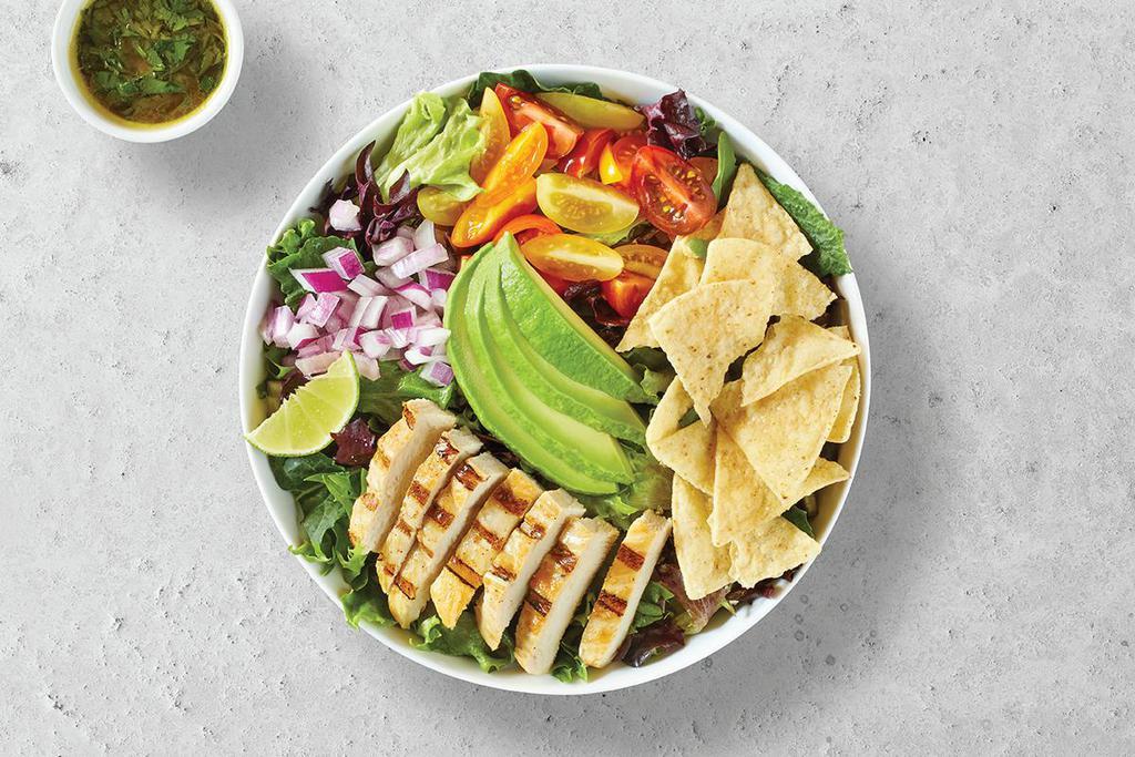 Avocado Green · Fresh grilled chicken breast, avocado, red onions, cherry tomatoes, corn chips on a bed of spring mix greens, with honey and fresh squeezed lime vinaigrette on the side.