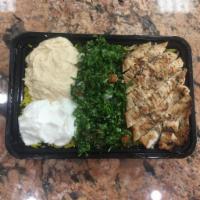 Grilled Chicken Bowl · Marinated and Grilled Chicken Breast on a bead of yellow rice, Taboli, Hummus and garlic Sauce