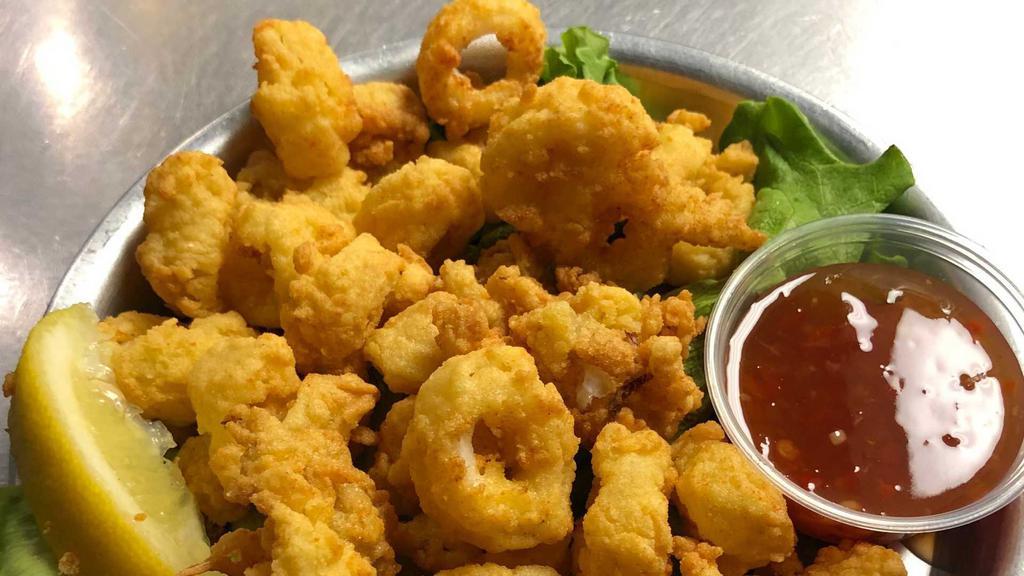Calamari · Hand-breaded, flash-fried, and served with a sweet and spicy sauce.
