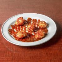 Scallops Wrapped in Bacon · Tender scallops wrapped in hickory smoked bacon served in a horseradish barbecue sauce.