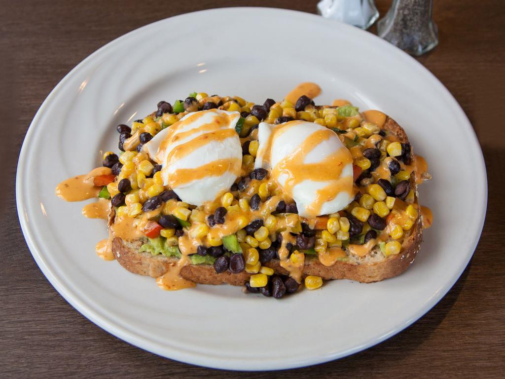 Avocado Toast · Toasted multi-grain, topped with an avocado spread, grilled corn, black bean, jalapeno, sriracha aioli and poached eggs served with hash browns. 