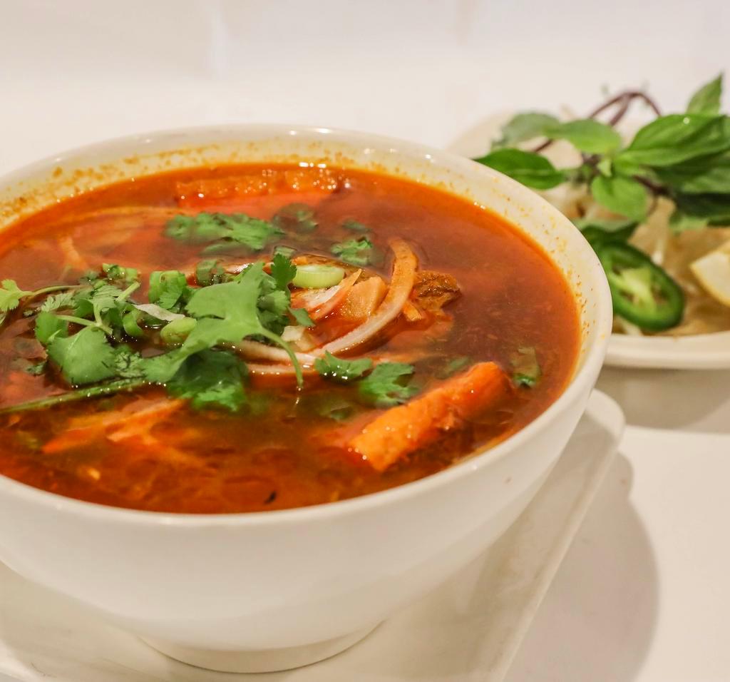 N16. Spicy Noodle Soup · Spicy vegetable broth with lemongrass flavor, thick rice noodle, organic tofu, soy protein, served with bean sprout and basil leaves.