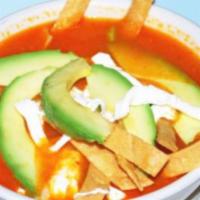 Sopa Azteca · Tomato soup with chipotle sauce and fried strip tortilla, topped with tropical cheese and av...