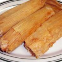 Tamales Poblanos · 2 mole tamales filled with chicken cover with mole sauce, red onions & sesame seeds.