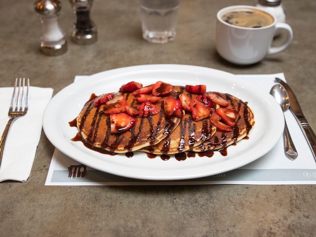 Berry Chocolaty Pancake · Chocolate chip pancakes topped with fresh strawberries and a chocolate drizzle. 