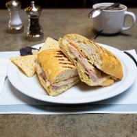Pavo Cubano Sandwich · Our version of the popular Cuban sandwich. ham, roasted turkey breast, Swiss cheese, tomato,...