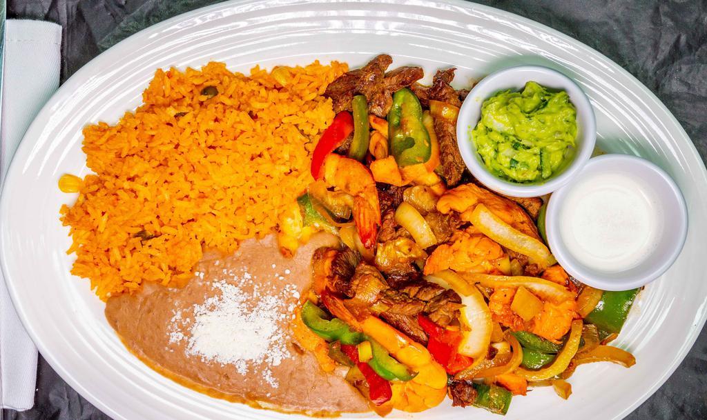 El Patron Fajitas · Fresh grilled strips of steak, chicken & shrimp cooked with onions, tomatoes, jalapeños - served with Mexican rice and beans, tortillas, Mexican sour cream with sides of pico de gallo & guacamole.