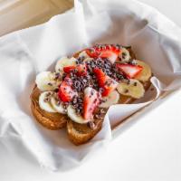Almond Butter Toas · Almond butter on multi grain bread, banana, strawberry, cacao nibs and honey.