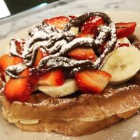 Strawberry Banana Nutella Waffle (served in the AM only) · Strawberrys, bananas, Nutella and powdered sugar on a waffle.