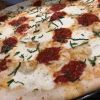 Margherita Pie · Made with plum tomatoes and fresh mozzarella.