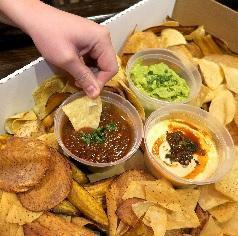 Quesomole Box · The perfect accompaniment for any event.  Our Quesomole box comes with Guacamole, Queso and Fire Roasted Salsa along with our blend of housemade malanga, plantain and tortilla chips.