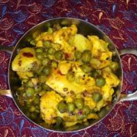 Aloo Gobhi · Potato and cauliflower cooked with onions, tomatoes and spices. Vegan.