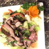 23. Beef Salad · Slice grilled steak mixed with lime juice, chili, cucumbers, red onions, tomatoes, green let...
