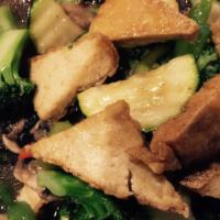 60. Tofu Delights · Crispy tofu topped with mushroom, zucchini, bell pepper and broccoli in bean sauce. Served w...