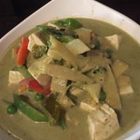43. Green Curry · Coconut milk, bamboo stripes, bell peppers, peas, carrots, Thai basil and eggplant in green ...