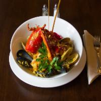 Magnos Paella · Lobster, shrimp, mussels, clams, chorizo, chicken scallops and saffron rice.