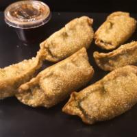 6 Pieces Pork Gyoza · Pan seared Japanese dumplings served with our homemade sauce.