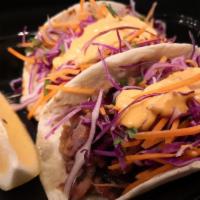 BBQ Pork Tacos  · Grilled tender pork, Hawaiian slaw, toasted sesame seeds and spicy mayo.