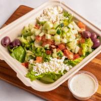 Greek Salad · Chopped lettuce, tomatoes, and cucumbers topped with feta cheese, Kalamata olives, and Greek...