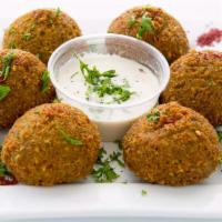 Falafels · Deep fried patties made of ground chickpeas mixed with herbs & served with tahini sauce.
