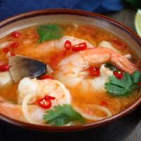 Tom Yum Shrimp · Clear spicy lemongrass with Thai herbs, mushrooms, cherry tomatoes, garnished with green oni...
