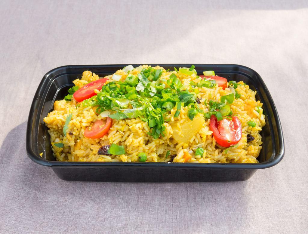 L7. Pineapple Fried Rice · Island fried rice, choice of protein, egg, garlic, white onion, peas, pineapple chunks, and cashew nuts garnished with cilantro and green onions.
