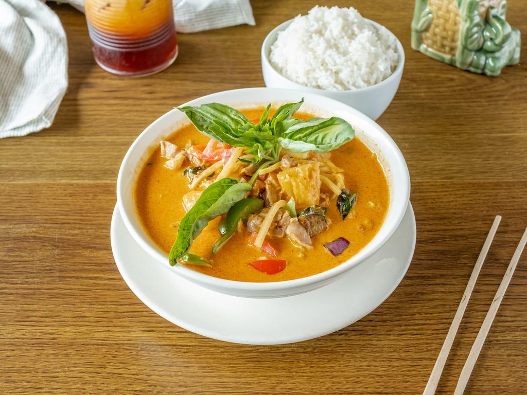 C7 Duck Curry · Red curry paste with roasted duck, eggplant, bamboo shoot, pineapple, bell pepper, tomato, and basil leaves.