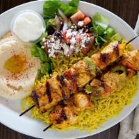 Chicken Kabab · Two skewers of chicken kabab, served with grilled green peppers, and tomato rice, Greek sala...