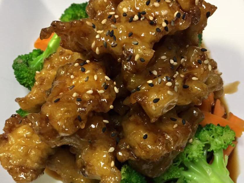 Sesame Chicken · Deep fried white meat chicken with honey glaze sesame sauce and steamed vegetable.