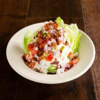 Pitched Wedge Salad · A quarter head of iceberg lettuce, drizzled with bleu cheese dressing, topped with bacon bit...