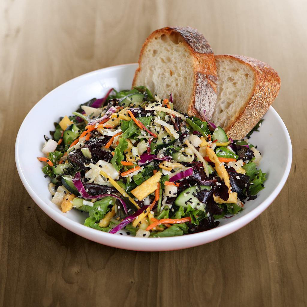 Asian Salad · organic field greens, green & red cabbage, cucumbers, organic carrots, celery, jicama, scallions, toasted sesame seeds, crispy noodles & all-natural thai peanut dressing served with artisan bread