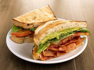 BLT Plus Sandwich · bacon, lettuce, tomatoes, cheddar, avocado, herb mayo on toasted sourdough & served with a side