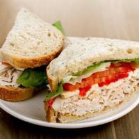 Turkey & Brie Sandwich · all-natural turkey breast, brie, roasted red peppers, lettuce, tomatoes, grain mustard on so...