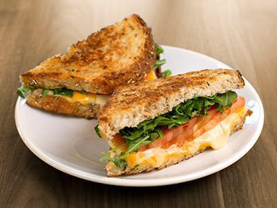 Wildflower Grilled Cheese Sandwich · swiss, brie, cheddar, organic arugula, tomatoes on nine grain & served with a side