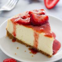 New York Style Cheesecake · New York Style Cheesecake with Strawberries on the side.