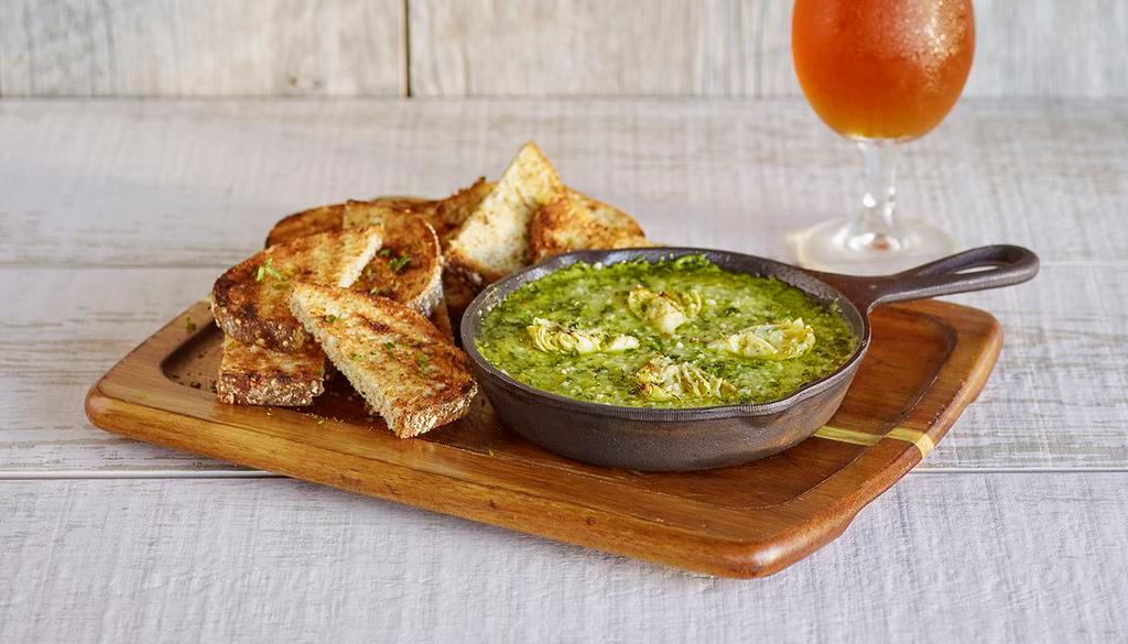 Baked Spinach & Artichoke Dip · House-made spinach and artichoke dip topped with parmesan cheese & baked, served with grilled multigrain bread.