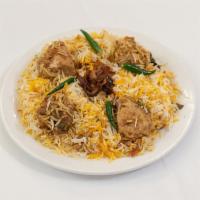 Chicken Biryani · Bone-in chicken marinated in yogurt and traditional spices cooked with basmati rice garnishe...