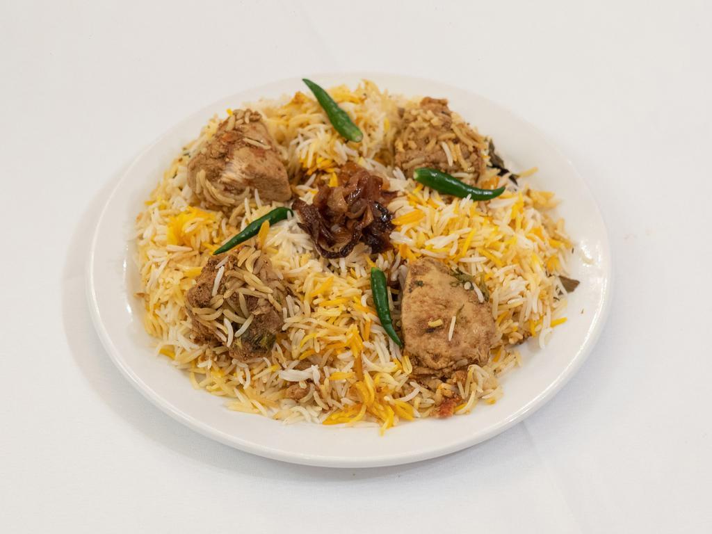 Chicken Biryani · Bone-in chicken marinated in yogurt and traditional spices cooked with basmati rice garnished with saffron.