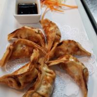 6. Pot Stickers · Deep-fried pot stickers filled with a mixture of ground chicken and vegetables. Served with ...