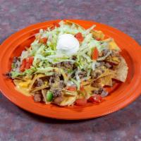 Nachos Grande Beef · Crispy tostadas topped with beans, cheese, , sour cream, garnish, and jalapenos.