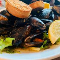 Garlicky Mussels · Prince Edward Island mussels steamed in white wine garlic basil sauce.
