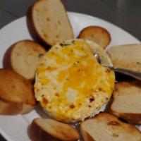 Crab Dip · A savory mix of lump crab meat, Italian cheeses and a touch of Old Bay, served with toasted ...