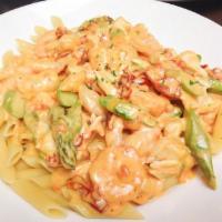 Shrimp and Crab Penne · Shrimp, lump crab meat, sun-dried tomatoes, and fresh asparagus sauteed in a white wine crea...