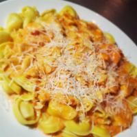 Shrimp and Crab Tortellini · Smoked mozzarella-filled tortellini pasta, topped with sauteed shrimp and crab meat in a pin...