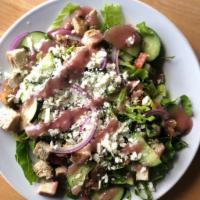 House Salad · Fresh romaine lettuce, marinated tomatoes, cucumbers, red onion, and feta cheese with house ...