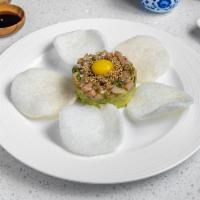 Toro Tartare · Diced fatty tuna with avocado, green onion, quail egg, served with lobster chips.